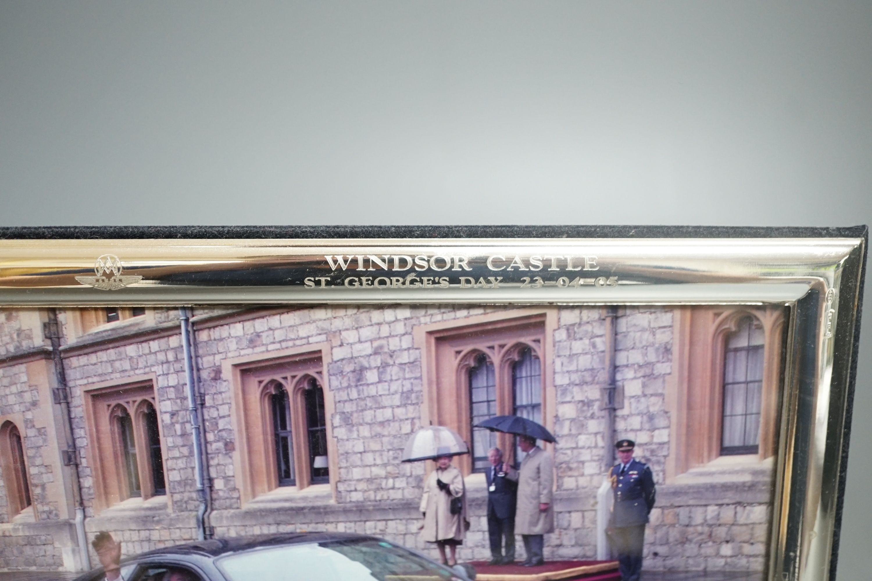A modern Italian 925 mounted photograph frame, engraved with the Aston Martin Owners Club emblem and inscribed 'Windsor Castle St. Georges Day 23/04/05', 23.1cm by 18.2cm.